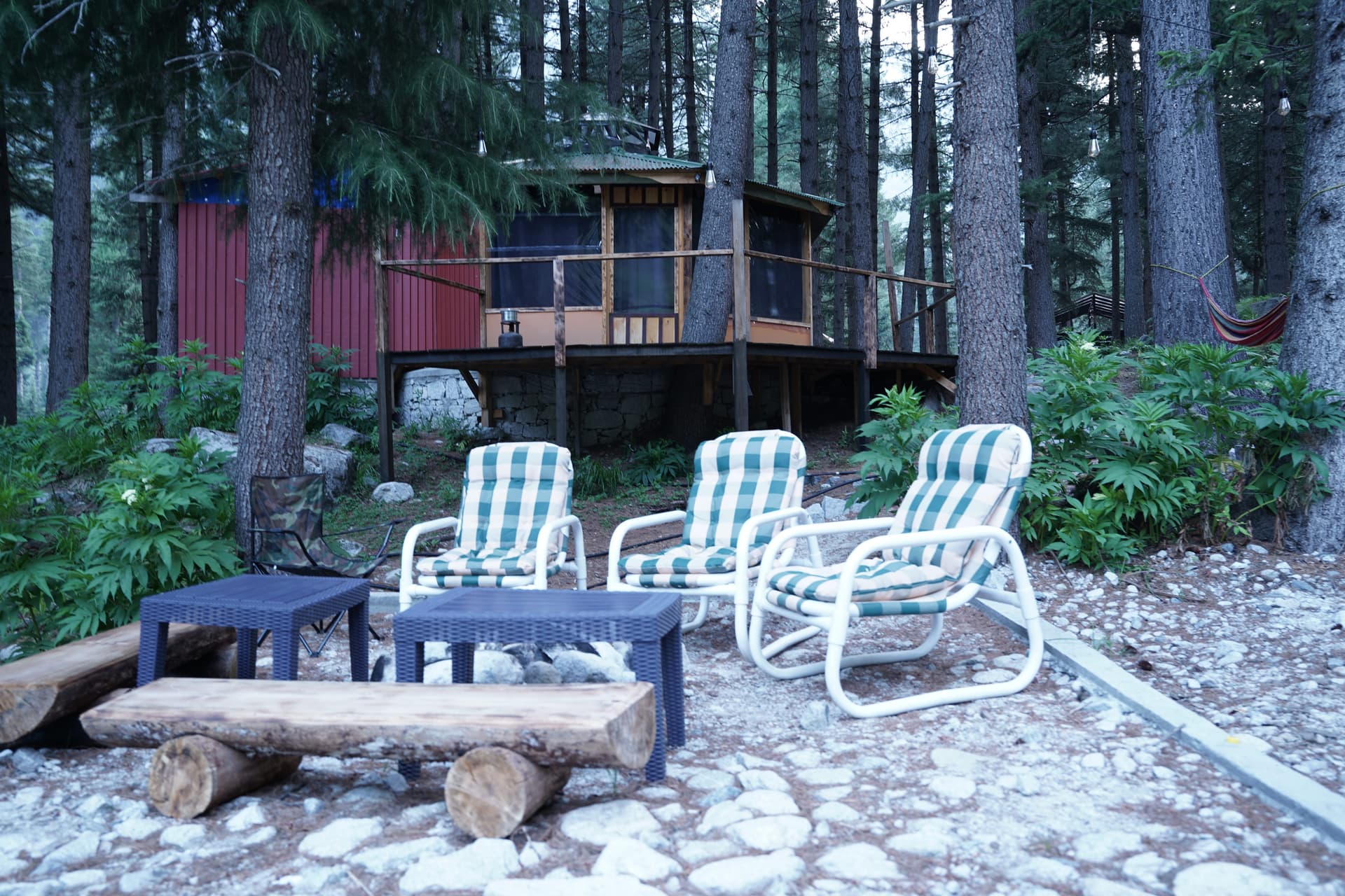 Evening outdoor lounge with striped chairs and fire pit