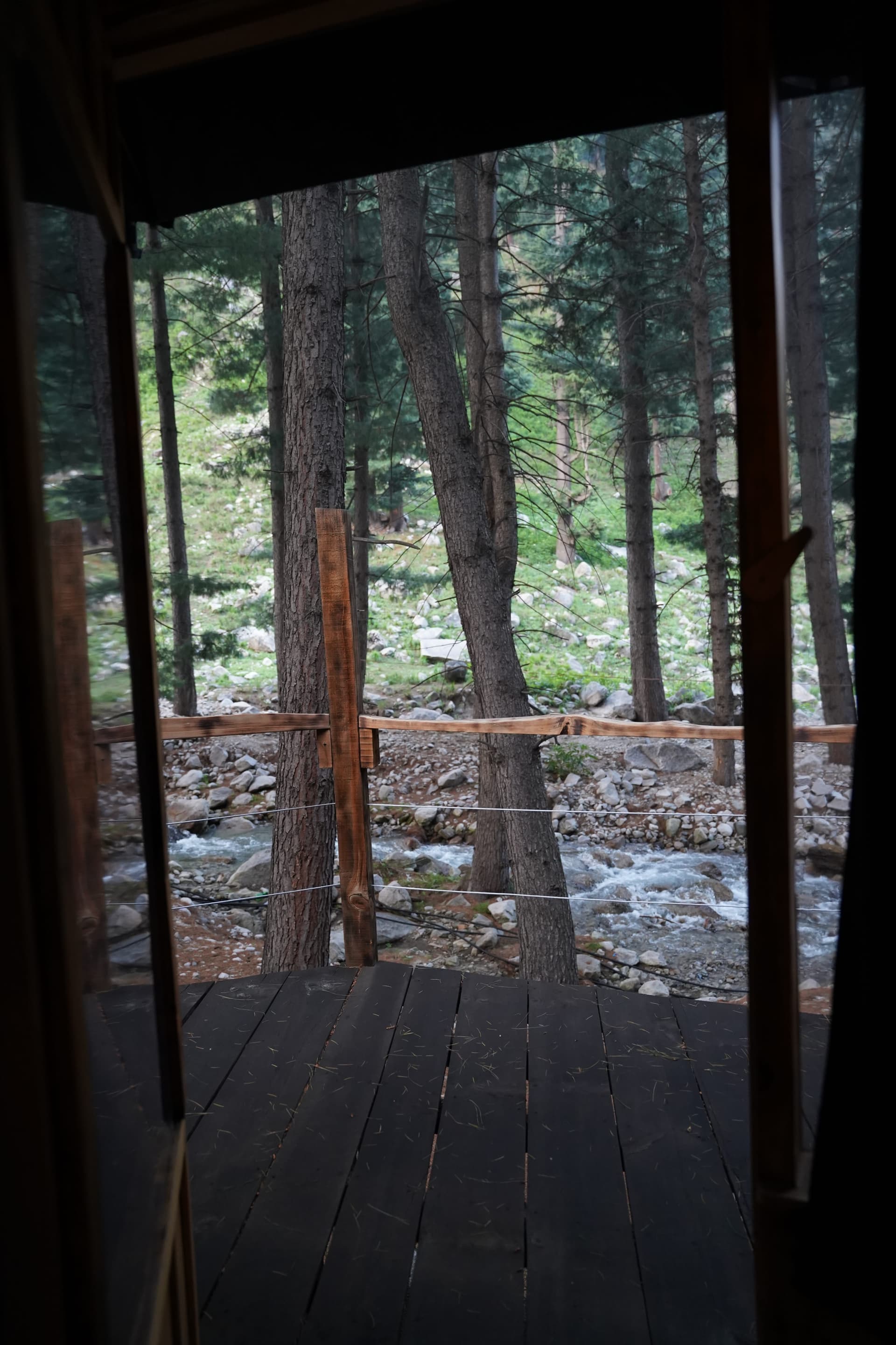 Deck view overlooking stream and forest